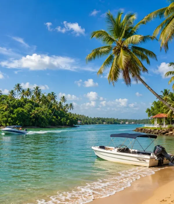 Bright daytime view of Bentota Beach with turquoise water, palm trees, sandy shore, and tropical coastal scenery.