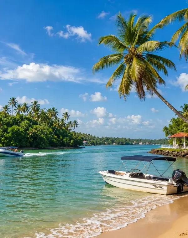 Bright daytime view of Bentota Beach with turquoise water, palm trees, sandy shore, and tropical coastal scenery.