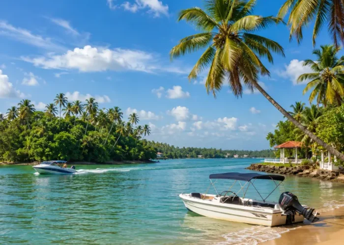 Bright daytime view of Bentota Beach with turquoise water, palm trees, sandy shore, and tropical coastal scenery.