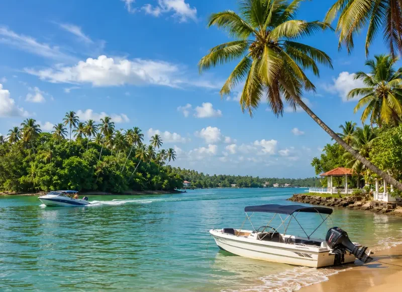 Bright daytime view of Bentota Beach with turquoise water, palm trees, sandy shore, and tropical coastal scenery.