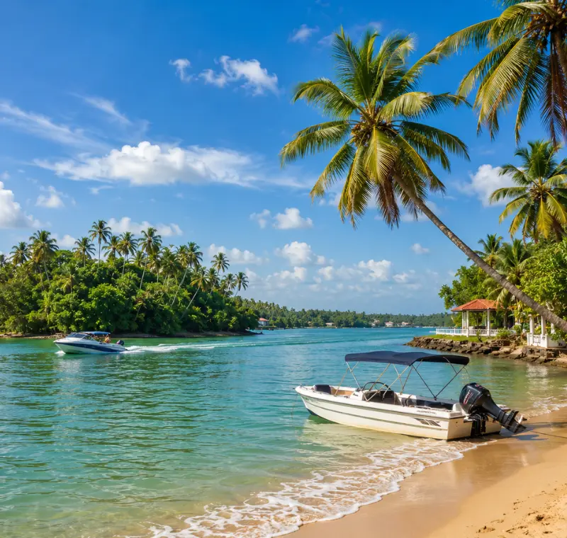 Bright daytime view of Bentota Beach with turquoise water, palm trees, sandy shore, and tropical coastal scenery.
