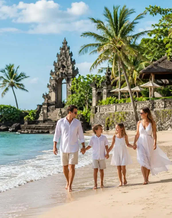 Family enjoying Bali beach with turquoise sea, golden sand, palm trees, and Balinese resort architecture.