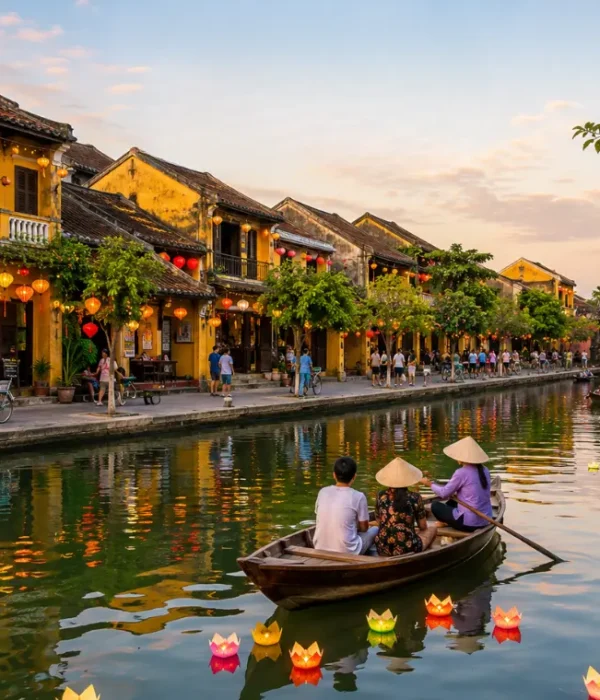 Hoi An, Vietnam ancient town with lantern-lit riverside houses, wooden boats, canal reflections, and Japanese Bridge.