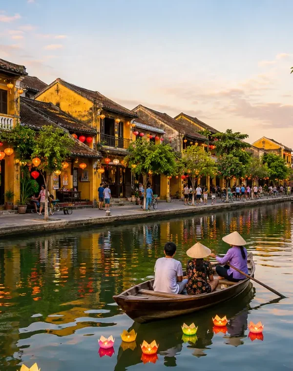 Hoi An, Vietnam ancient town with lantern-lit riverside houses, wooden boats, canal reflections, and Japanese Bridge.