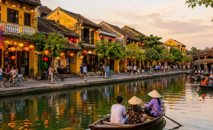 Hoi An, Vietnam ancient town with lantern-lit riverside houses, wooden boats, canal reflections, and Japanese Bridge.