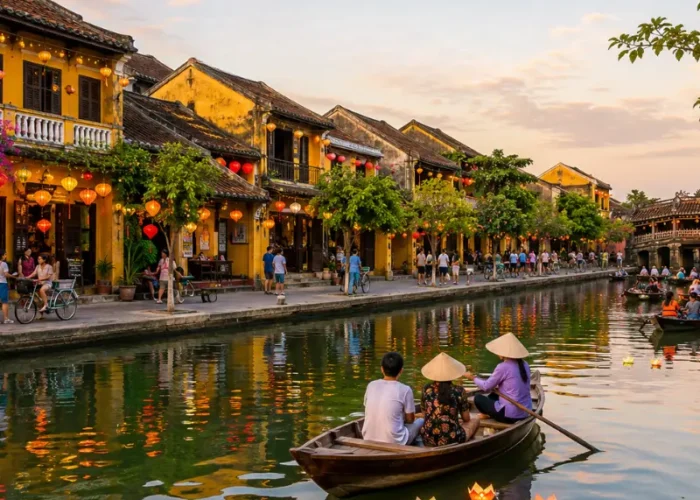 Hoi An, Vietnam ancient town with lantern-lit riverside houses, wooden boats, canal reflections, and Japanese Bridge.
