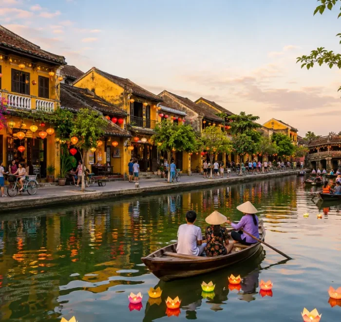 Hoi An, Vietnam ancient town with lantern-lit riverside houses, wooden boats, canal reflections, and Japanese Bridge.