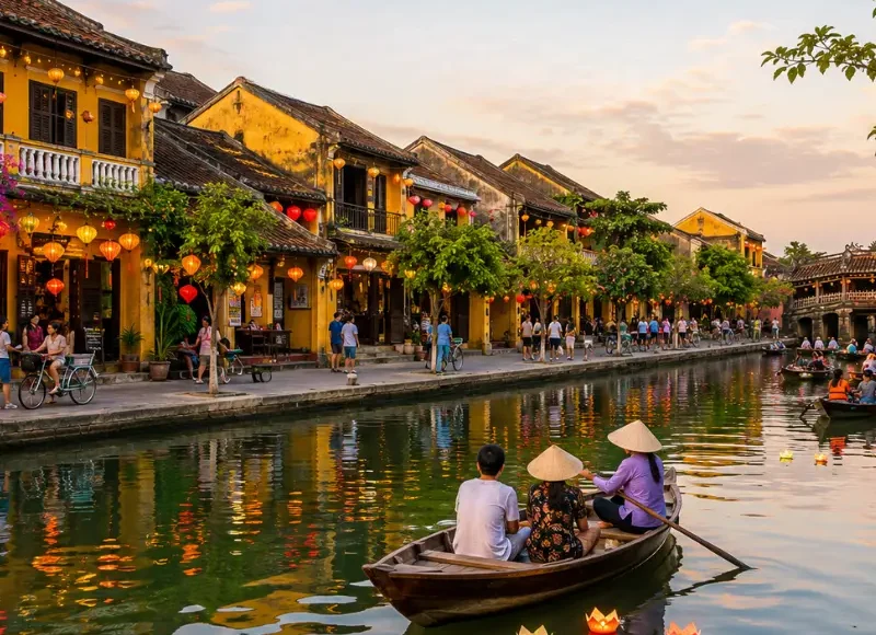 Hoi An, Vietnam ancient town with lantern-lit riverside houses, wooden boats, canal reflections, and Japanese Bridge.