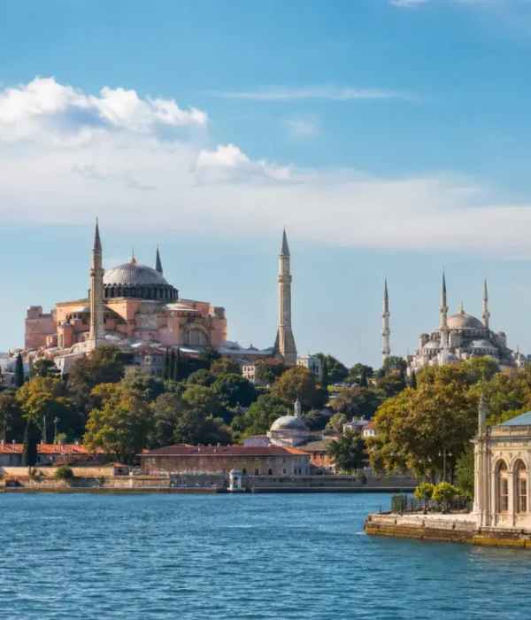 Bright daytime view of Istanbul with Hagia Sophia, Blue Mosque, historic skyline, and calm Bosphorus waterfront.