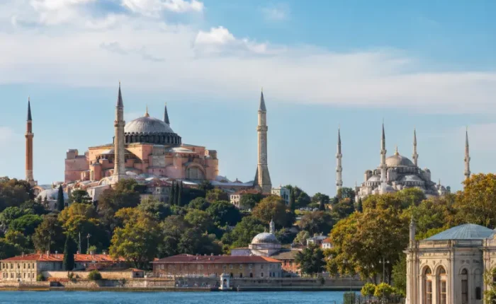 Bright daytime view of Istanbul with Hagia Sophia, Blue Mosque, historic skyline, and calm Bosphorus waterfront.