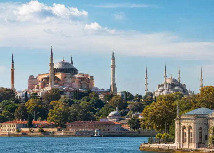 Bright daytime view of Istanbul with Hagia Sophia, Blue Mosque, historic skyline, and calm Bosphorus waterfront.
