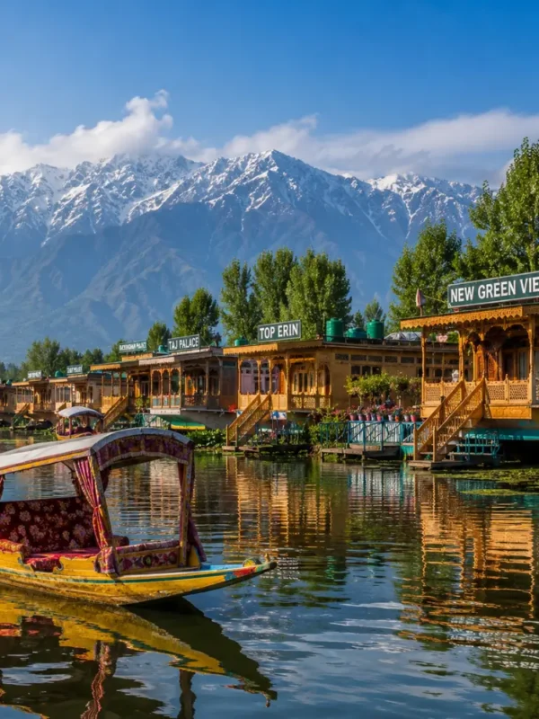 Srinagar houseboat on Dal Lake with calm water, wooden shikara, Himalayan hills and clear morning daylight.