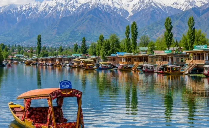 Srinagar with Dal Lake, shikaras, Mughal gardens, wooden houseboats and Himalayan mountains in clear morning light.