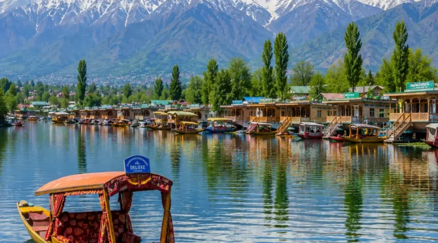 Srinagar with Dal Lake, shikaras, Mughal gardens, wooden houseboats and Himalayan mountains in clear morning light.