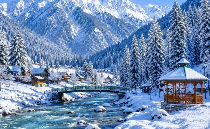 Kashmir with snow-covered valleys, pine forests, frozen meadows and Himalayan mountains in clear morning light.