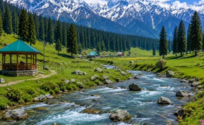 Doodhpathri Kashmir with green meadows, pine forests, flowing stream and snow-capped mountains in clear morning light.