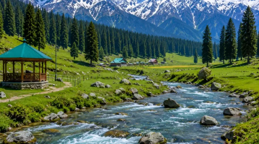 Doodhpathri Kashmir with green meadows, pine forests, flowing stream and snow-capped mountains in clear morning light.