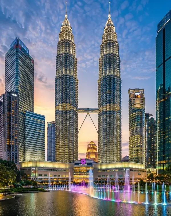 Kuala Lumpur skyline with Petronas Twin Towers, modern city buildings and clear blue daytime sky
