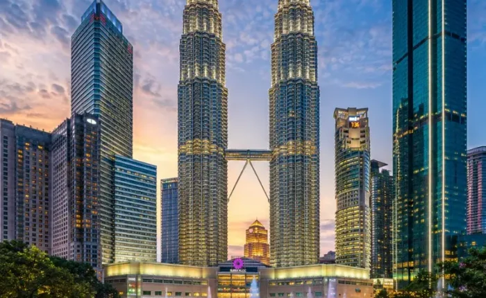Kuala Lumpur skyline with Petronas Twin Towers, modern city buildings and clear blue daytime sky
