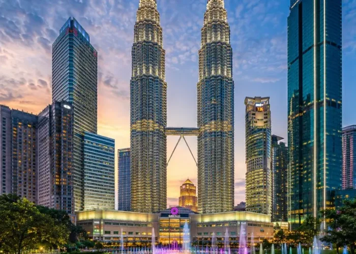 Kuala Lumpur skyline with Petronas Twin Towers, modern city buildings and clear blue daytime sky