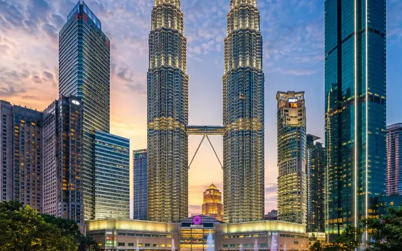 Kuala Lumpur skyline with Petronas Twin Towers, modern city buildings and clear blue daytime sky