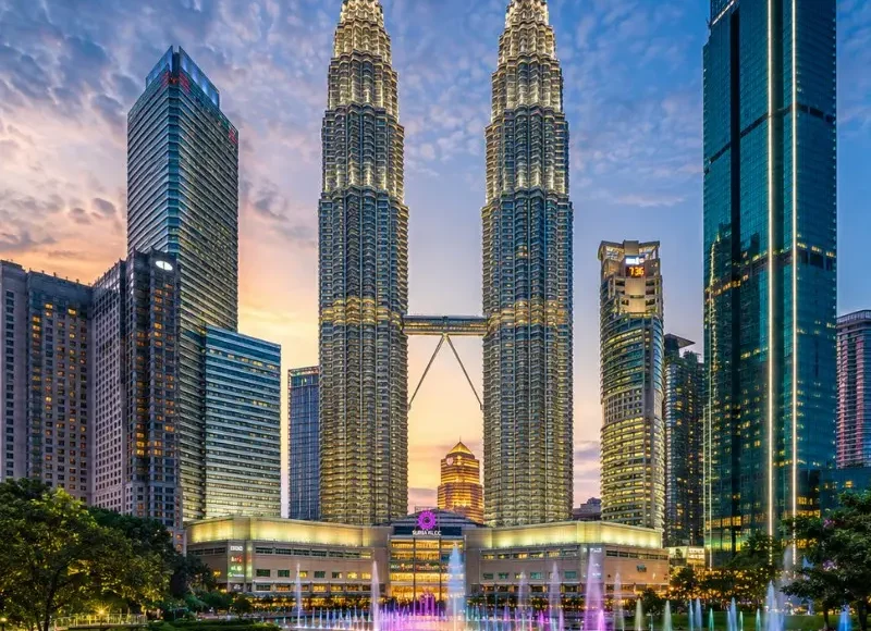 Kuala Lumpur skyline with Petronas Twin Towers, modern city buildings and clear blue daytime sky