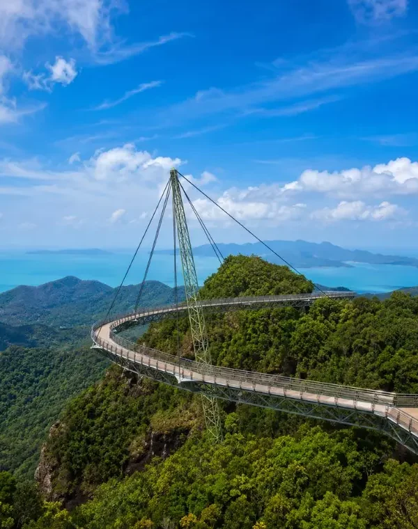 Langkawi Sky Bridge above lush rainforest with turquoise sea and island views in bright daylight