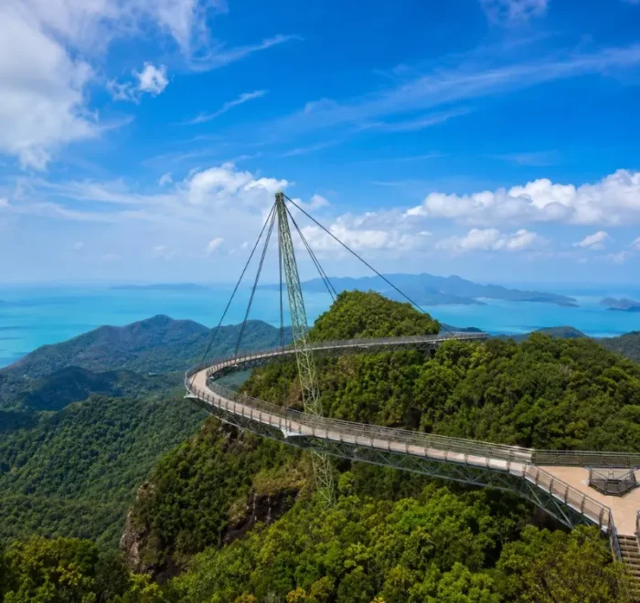 Langkawi Sky Bridge above lush rainforest with turquoise sea and island views in bright daylight