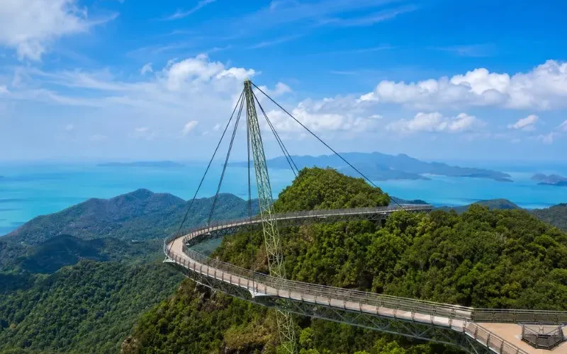 Langkawi Sky Bridge above lush rainforest with turquoise sea and island views in bright daylight