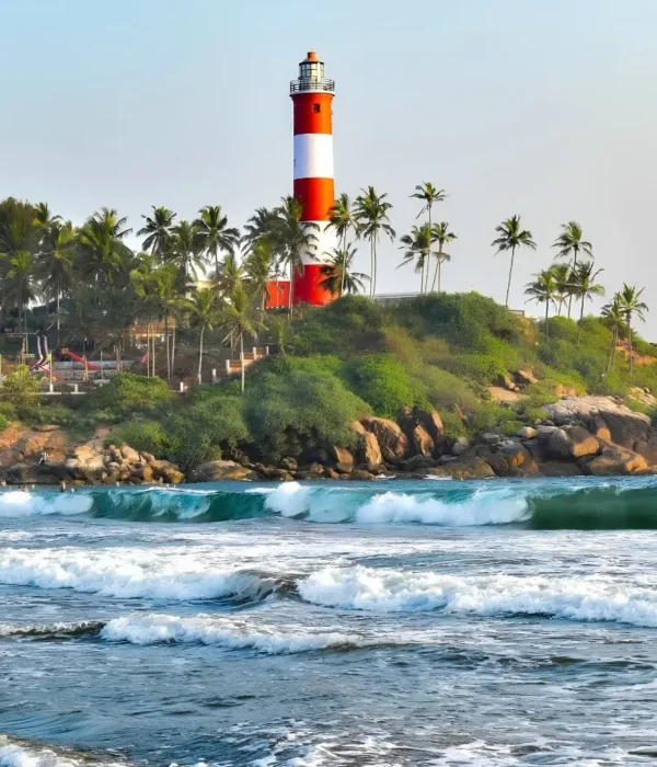 Munnar Thekkady Alleppey Kovalam package featuring Kovalam Lighthouse, palm-lined beach, sea waves and Kerala coastal beauty