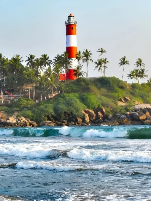 Munnar Thekkady Alleppey Kovalam package featuring Kovalam Lighthouse, palm-lined beach, sea waves and Kerala coastal beauty