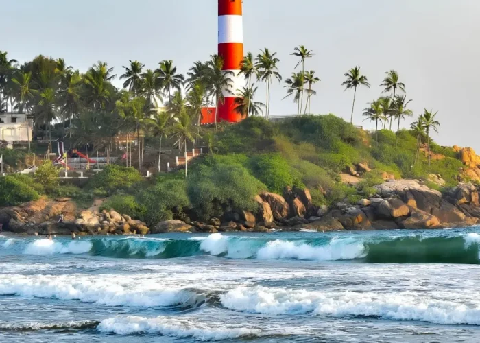 Munnar Thekkady Alleppey Kovalam package featuring Kovalam Lighthouse, palm-lined beach, sea waves and Kerala coastal beauty