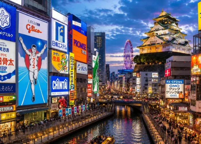 Vibrant Osaka city view with Dotonbori canal, neon streets, river boat, and Osaka Castle in the background.