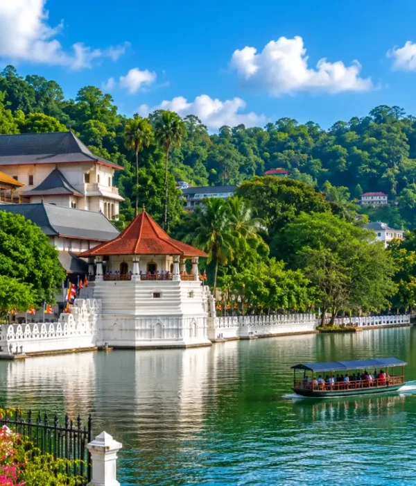 Bright daytime view of Kandy Sri Lanka with Kandy Lake, lush green hills, and the Temple of the Sacred Tooth Relic.