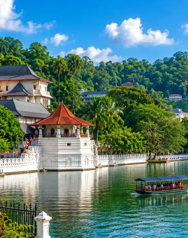 Bright daytime view of Kandy Sri Lanka with Kandy Lake, lush green hills, and the Temple of the Sacred Tooth Relic.