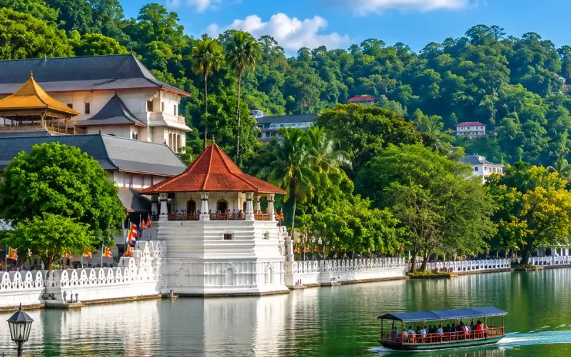 Bright daytime view of Kandy Sri Lanka with Kandy Lake, lush green hills, and the Temple of the Sacred Tooth Relic.