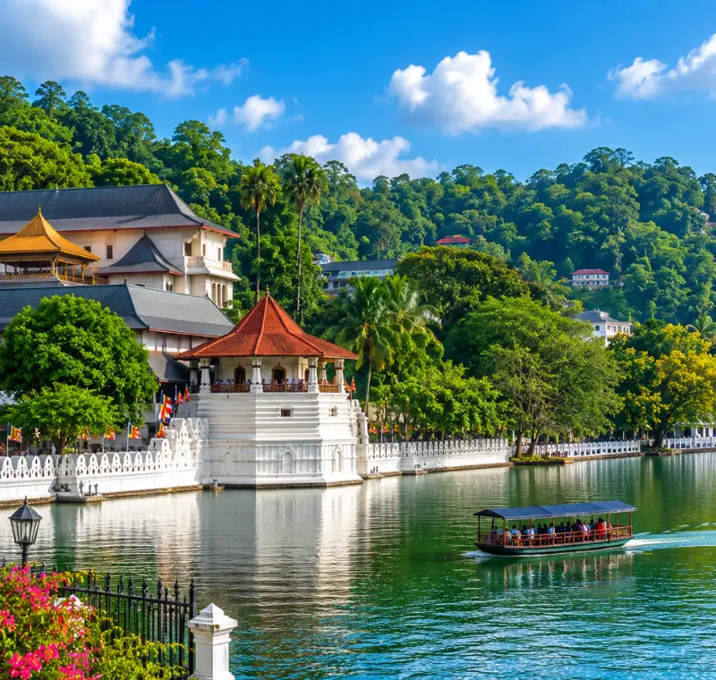 Bright daytime view of Kandy Sri Lanka with Kandy Lake, lush green hills, and the Temple of the Sacred Tooth Relic.