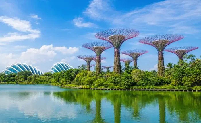 Gardens by the Bay Singapore with Supertree Grove, Flower Dome and lakeside reflection in bright daylight