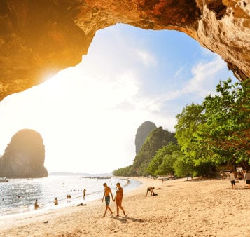 Scenic beach view in India with limestone cliffs, clear blue sky, and lush greenery, perfect for Indian beach holiday tours and travel adventures.
