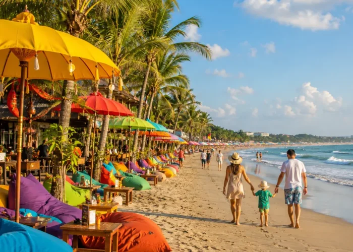 Seminyak Bali family beach tour with luxury resort pool, sandy beach, tropical palms, and bright morning atmosphere.