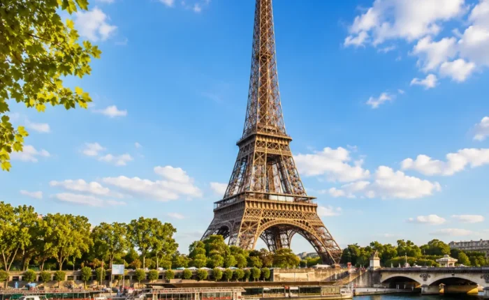 Eiffel Tower in Paris with elegant gardens, classic city views, clear sky, and bright morning European atmosphere.