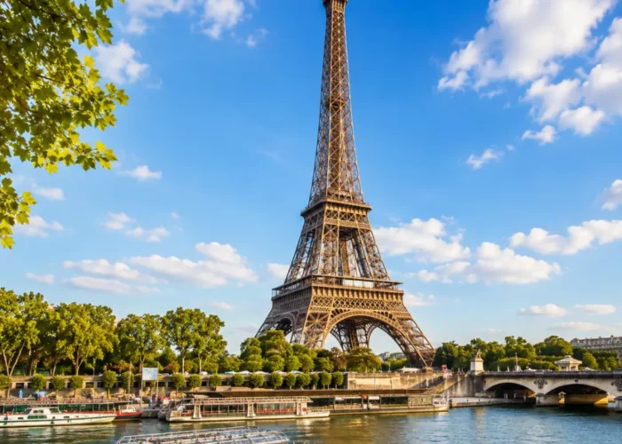 Eiffel Tower in Paris with elegant gardens, classic city views, clear sky, and bright morning European atmosphere.