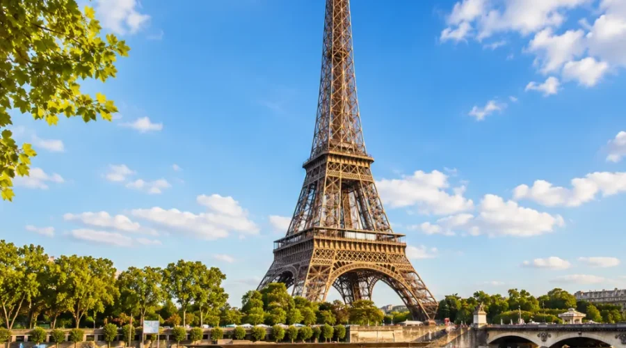 Eiffel Tower in Paris with elegant gardens, classic city views, clear sky, and bright morning European atmosphere.