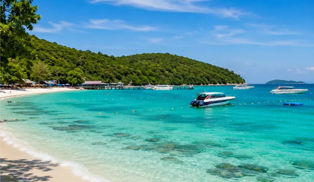 Pattaya Coral Island Thailand with turquoise sea, white sandy beach, speedboats, and bright morning tropical atmosphere.