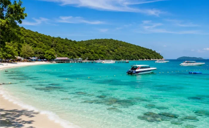 Pattaya Coral Island Thailand with turquoise sea, white sandy beach, speedboats, and bright morning tropical atmosphere.