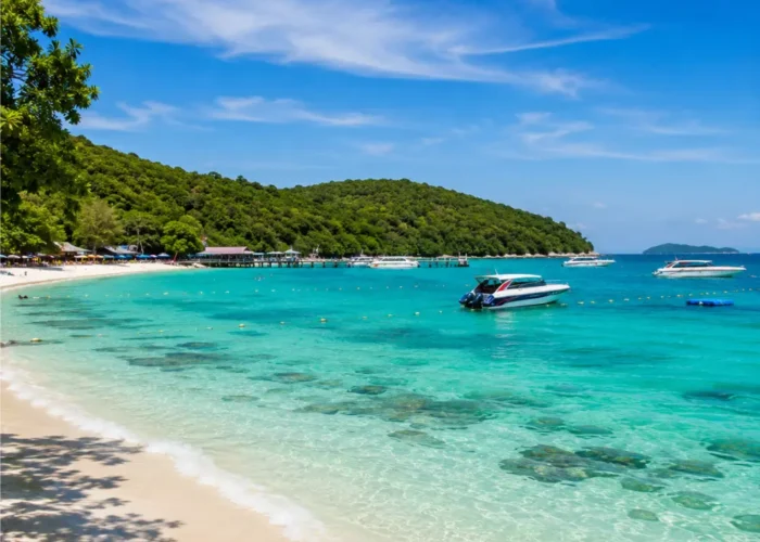 Pattaya Coral Island Thailand with turquoise sea, white sandy beach, speedboats, and bright morning tropical atmosphere.