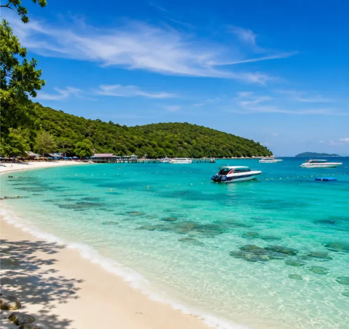 Pattaya Coral Island Thailand with turquoise sea, white sandy beach, speedboats, and bright morning tropical atmosphere.