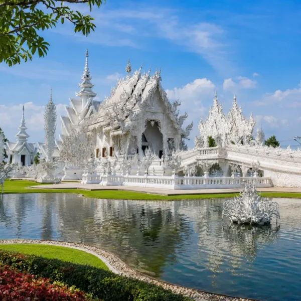 Chiang Rai Thailand with White Temple, ornate Thai architecture, lush gardens, and bright morning cultural atmosphere.