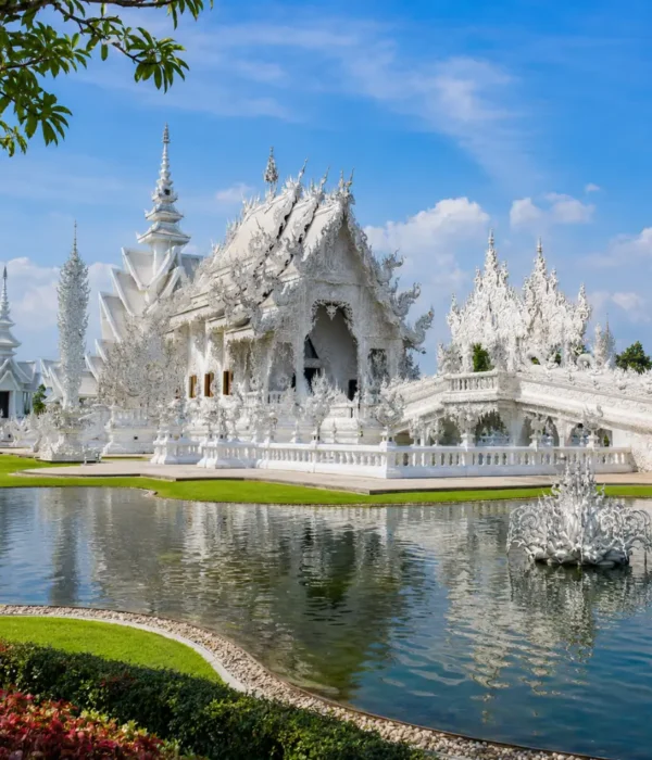 Chiang Rai Thailand with White Temple, ornate Thai architecture, lush gardens, and bright morning cultural atmosphere.
