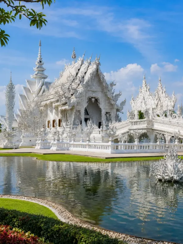 Chiang Rai Thailand with White Temple, ornate Thai architecture, lush gardens, and bright morning cultural atmosphere.